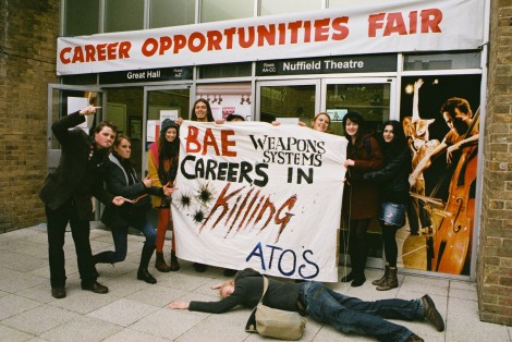Student protesters gather with banner reading 'Careers in Killing'
