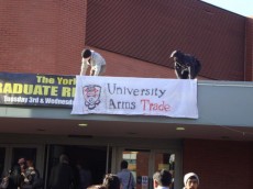 York students put a banner reading 'University Arms Trade' next to the Careers Fair banner